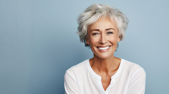 Smiling older woman with short gray hair, representing the benefits of same-day dental implants