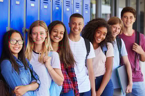 Group of smiling teenagers, representing the age group commonly affected by wisdom teeth issues